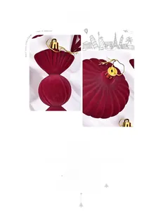 Macro view of velvet candy-shaped Christmas ornament with golden string and metallic cap