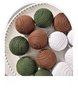 Detail of handmade woven Christmas tree ornaments in green, tan and beige cotton rope
