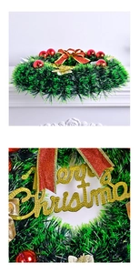 Detail of Christmas wreath with red bow, shiny baubles and golden Merry Christmas sign