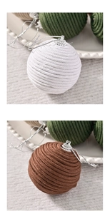 Macro detail of hand-woven cotton rope Christmas ball ornaments with spiral texture