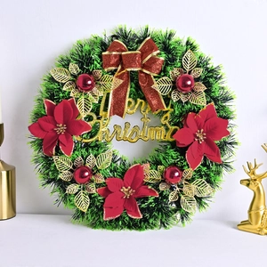 Christmas wreath with red bows, glitter leaves, and Merry Christmas sign on white background
