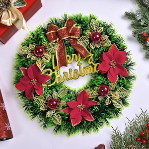 Christmas wreath with red bows, poinsettia flowers and Merry Christmas sign on white background