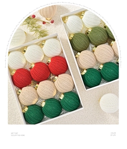 Detail of colorful hand-knitted Christmas balls with golden hooks in a white gift box