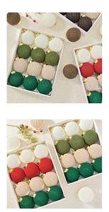 Detailed close-up of colorful crochet Christmas baubles with golden metallic hooks