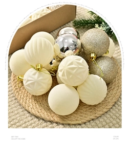 Detail of burgundy and cream flocked Christmas ornaments with glitter textures and gold hooks