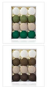 Detailed view of 12-piece crochet knit Christmas ball set with gold hooks in a gift box