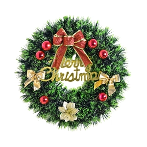 Christmas wreath with red bows, gold Merry Christmas sign and red ornaments on white backdrop