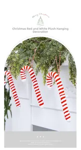 Detail of red and white striped plush candy cane ornament hanging on a festive mantel