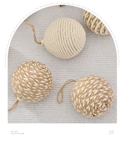 Detail showing natural jute and white cotton rope woven patterns on Christmas baubles