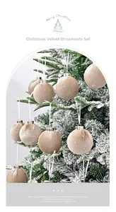 Close-up of champagne velvet Christmas ball with glitter meteor patterns on a snowy tree