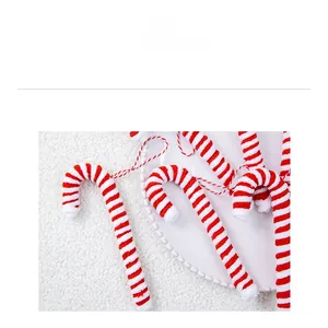 Detail of red and white striped plush candy cane ornaments with hanging loops