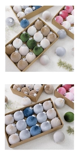 Detail of 8cm velvet Christmas balls in a gift box with a textured festive backdrop