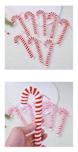 Detailed view of red and white striped plush candy cane ornaments with hanging strings