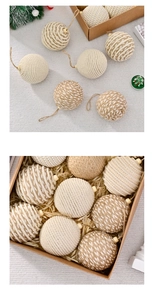 Close-up of 8cm woven cotton rope Christmas balls with pearl accents in a gift box