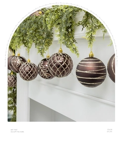 Detailed close-up of brown Christmas ornaments with gold glitter patterns on branches