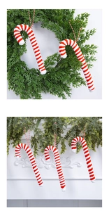 Detail of red and white striped candy cane ornaments hanging on a festive mantelpiece