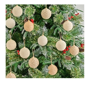 Detailed close-up of woven hemp rope Christmas balls hanging on a decorated tree branch