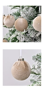Close-up of champagne gold velvet Christmas ball with silver star glitter on tree