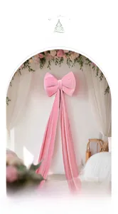 Close-up of pink velvet bow decoration with long tassels for romantic wedding party decor