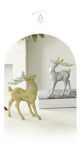 Macro detail of gold and silver glitter reindeer figurines for Christmas tabletop decor