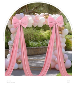 Close-up of large pink velvet bow ornament with long ribbons for wedding party decor