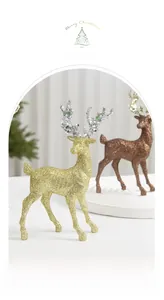 Detail of glittered elk figurines in gold and bronze for elegant Christmas desk decor
