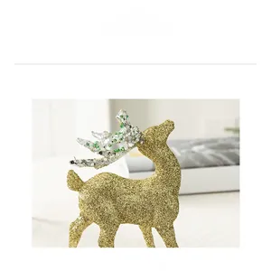 Close-up of golden glitter reindeer ornament with silver antlers for Christmas decor