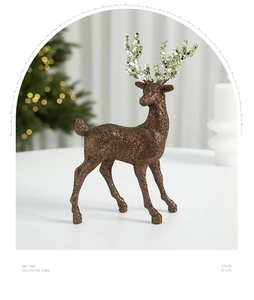 Glittering reindeer figurine decor on tabletop with a warm blurred Christmas tree background