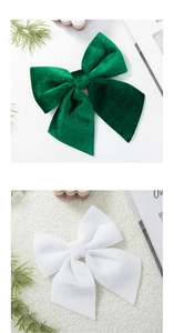 Close-up of premium velvet Christmas bows in dark green and white for festive tree decoration