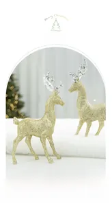 Detail of two gold glitter reindeer figurines with crystalline antlers for Christmas