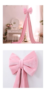 Close-up of a pink velvet decorative bow showing smooth texture and elegant long ribbons