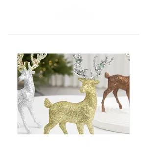 Macro shot of glitter-coated Christmas reindeer ornaments in gold, silver, and bronze