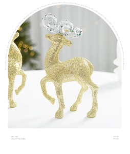 Close-up of golden glitter reindeer ornament with elegant transparent antlers for Christmas