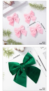 Detail of pink and green velvet Christmas bows showing fabric texture and sizes