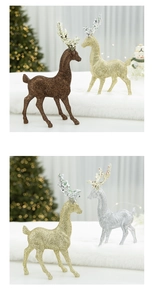 Glittery reindeer ornaments in gold and silver on white faux fur with festive lighting