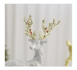 Detailed close-up of glittery silver Christmas reindeer with elegant golden antlers