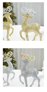 Close-up of glitter-coated reindeer figurines in gold and silver for Christmas decor