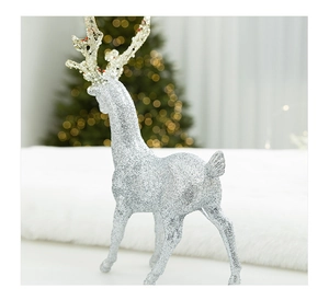 Macro detail of a silver glitter reindeer ornament with golden antlers for Christmas decor