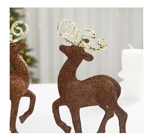 Close-up of glittery brown Christmas reindeer ornament with sparkling spiral antlers