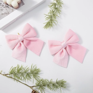 Set of two pink velvet Christmas bow hanging ornaments for holiday tree decoration