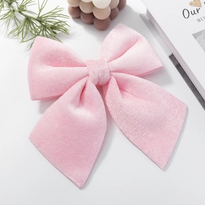 Pink velvet Christmas bow ornament for tree decoration with a soft plush texture