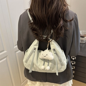 Light green nylon tote backpack with plush cloud charm shown as a versatile shoulder bag