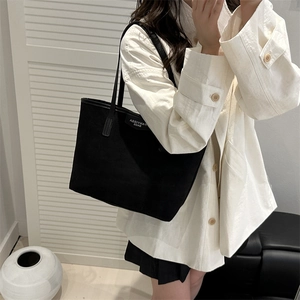 Classic black matte tote bag with slim shoulder straps and minimalist design for women
