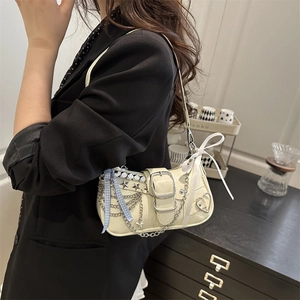 Beige chic shoulder bag with silver chains, star studs and Y2K trendy aesthetic