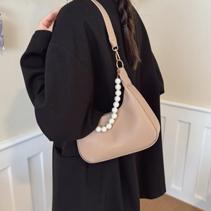 Beige faux leather half-moon underarm bag with pearl strap and gold fashion logo