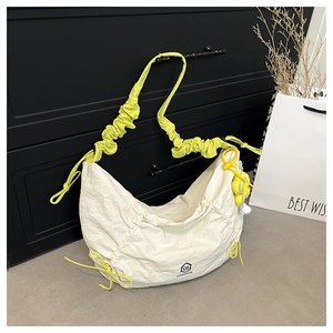 Detail of off-white pleated tote bag with neon yellow drawstrings and sunflower charm