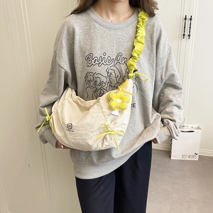 Chic pleated croissant bag in off-white with yellow flower charm and knotted straps