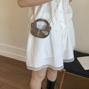 Detail of gunmetal grey structured handbag with unique ring handle and gold chain