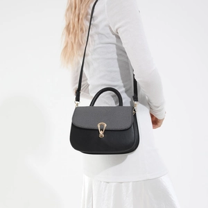 Women's chic contrast shoulder bag in black and grey leather with gold geometric buckle