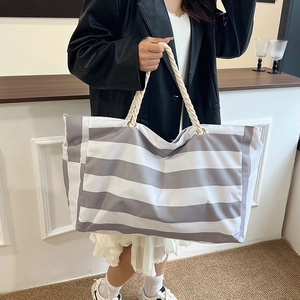 Chic striped canvas tote bag with thick rope handles and spacious interior for daily use